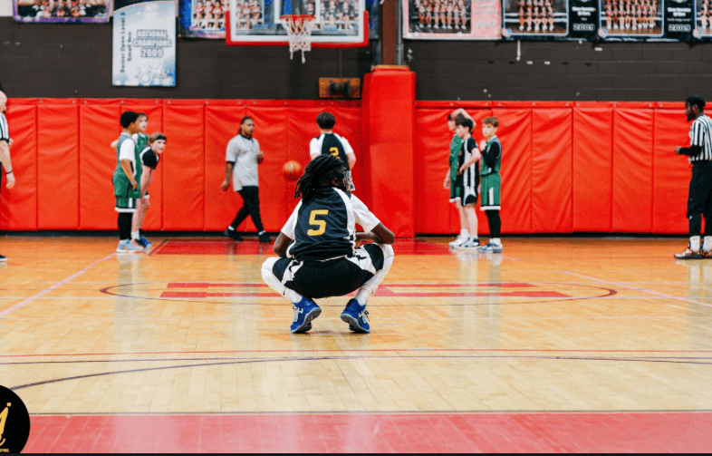 A Hudson middle school player brings the ball up court during a basketball game