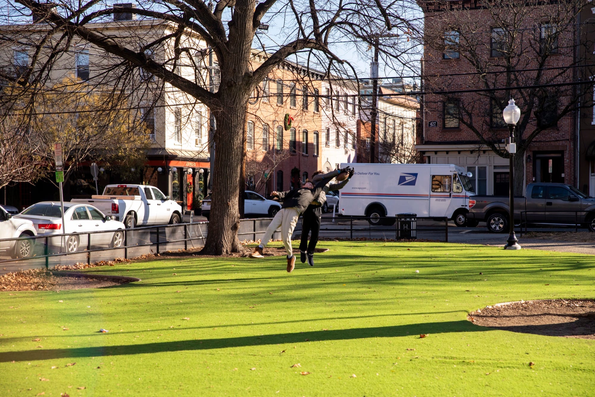 Hudson School students playing soccer on a sunlit park lawn