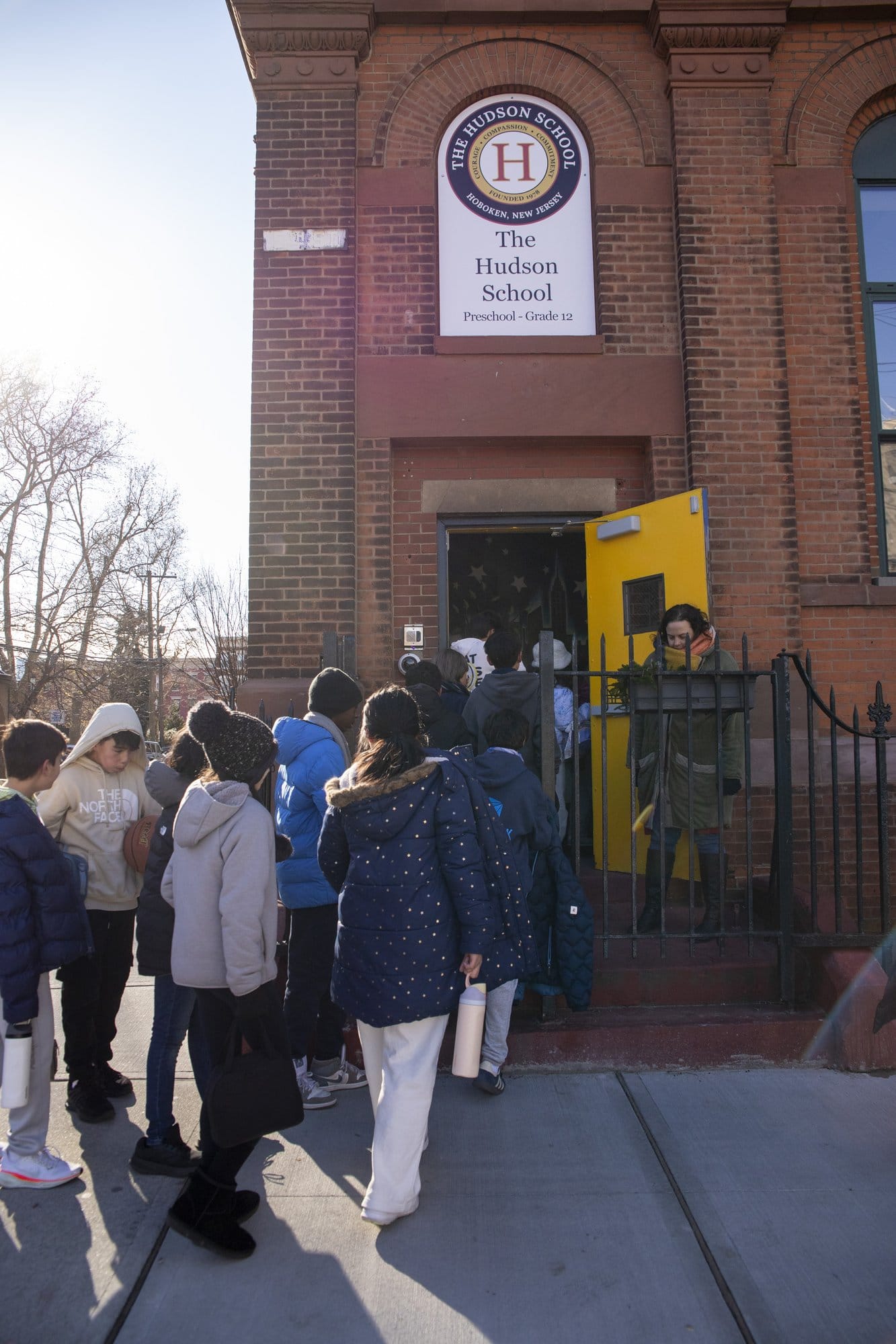 Red brick school exterior stop sign and entrance