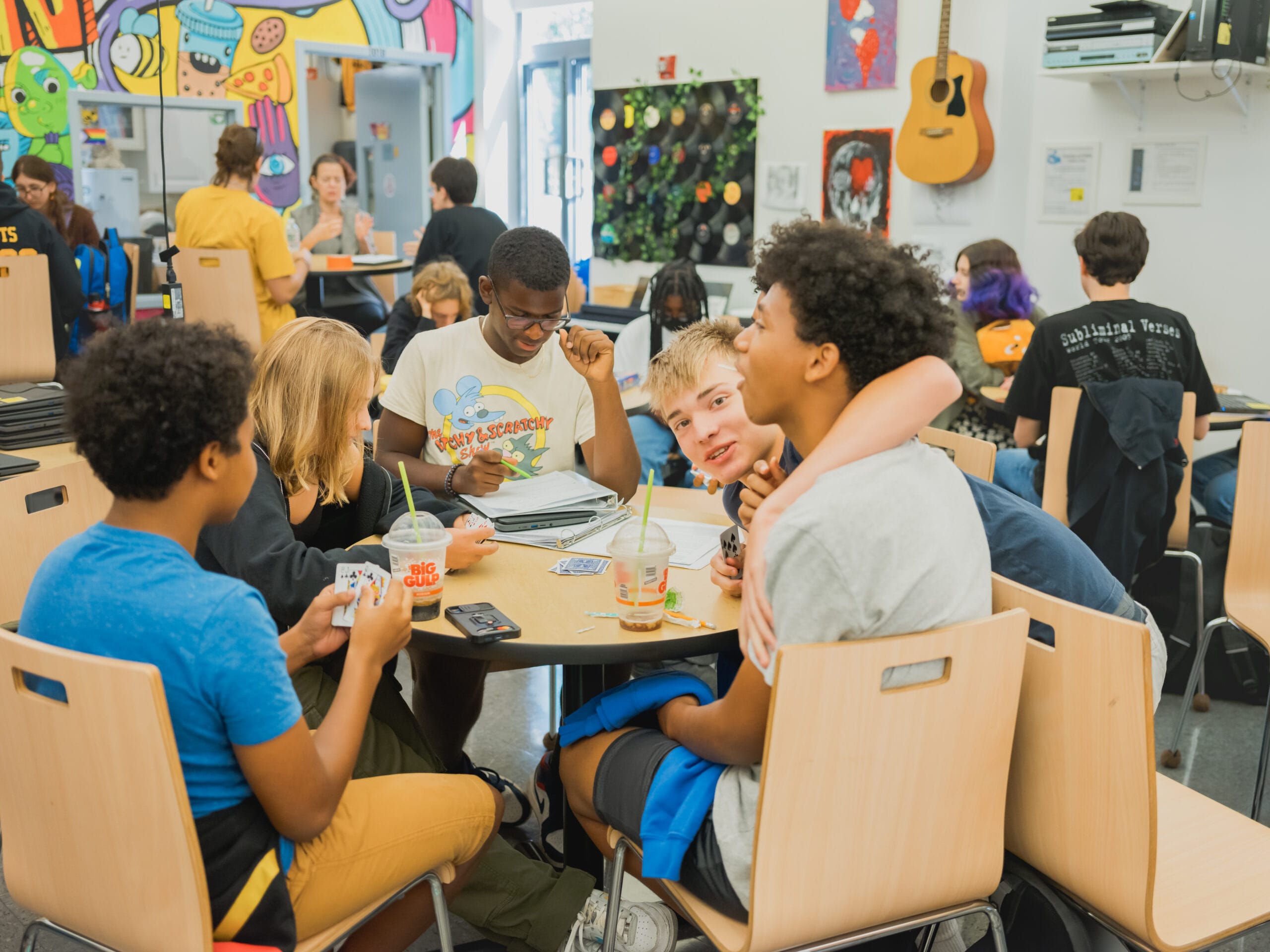 Upper School students play cards together in the student lounge during break