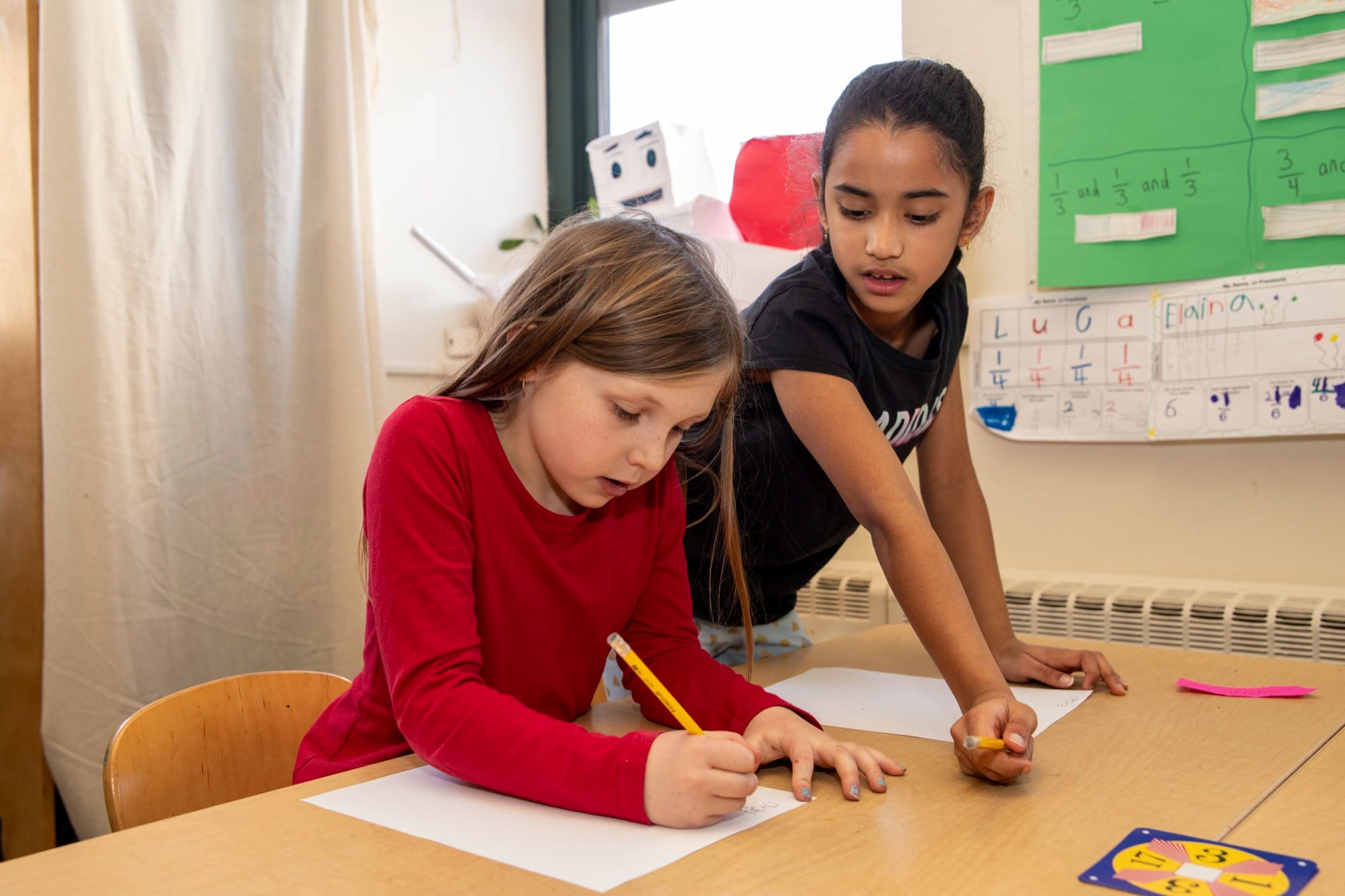 Middle School students collaborating on classwork