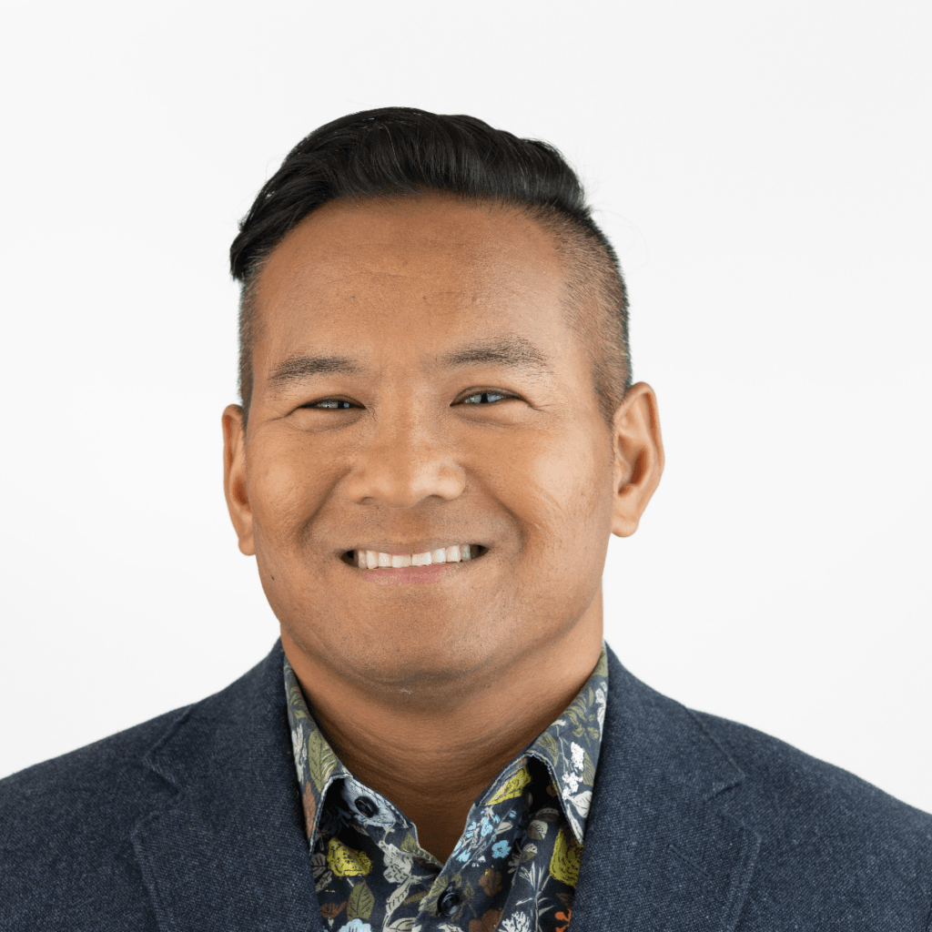 Nat Smitobol, College Counselor at The Hudson School, smiling in a blazer